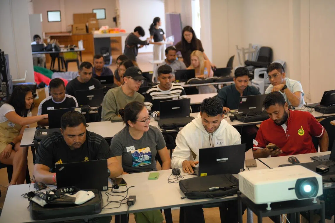 Migrant workers and volunteers during their computer class  at Colours Friendship Centre at Sembawang Recreation Centre on Sept 15.