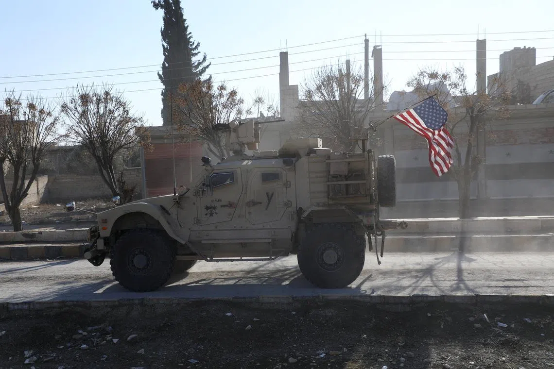 FILE PHOTO: A U.S. military vehicle moves on a road on the day of a meeting between the Syrian Democratic Forces (SDF) leaders and U.S. military leaders, in Deir Hafer, Syria. January 16, 2026. REUTERS/Orhan Qereman/ File Photo