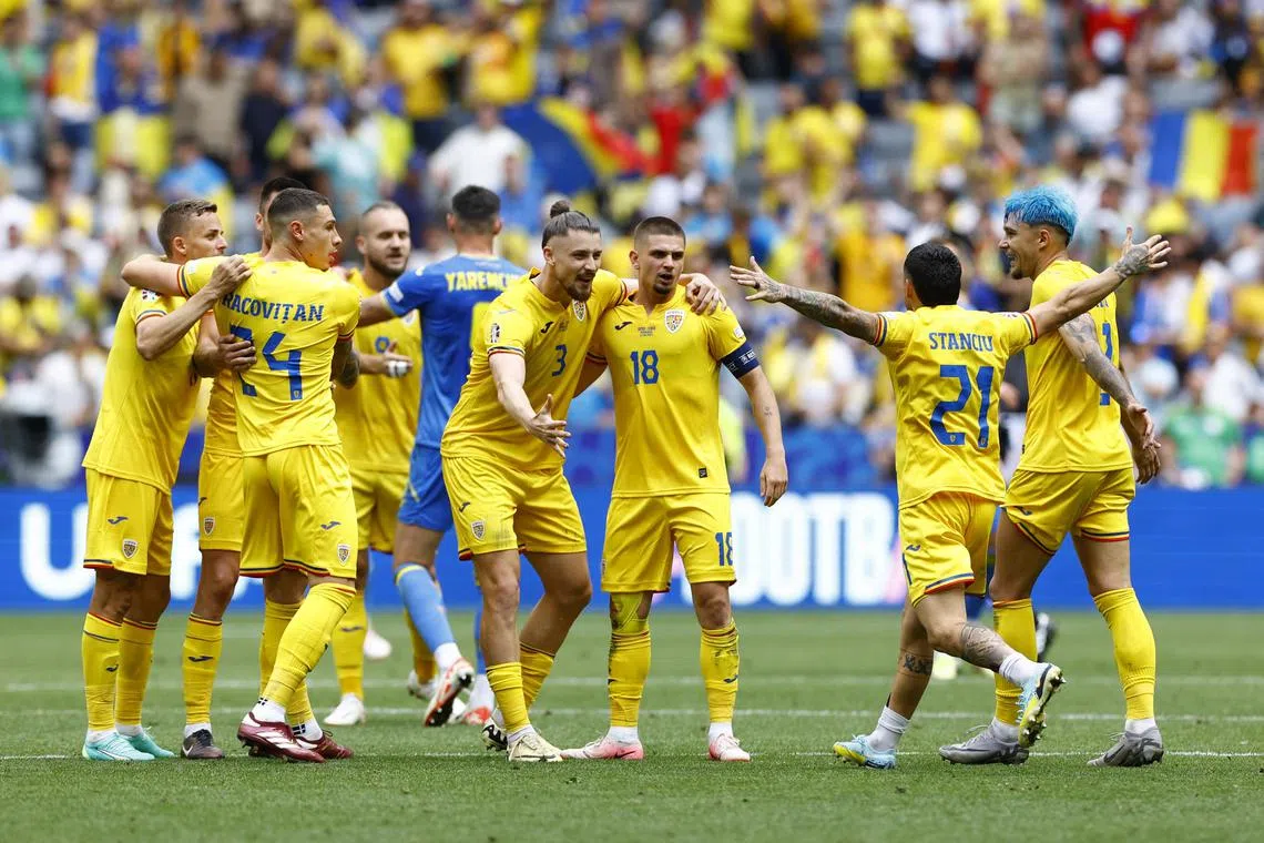 Romania's Radu Dragusin, Razvan Marin, Nicolae Stanciu and Andrei Ratiu celebrating after the 3-0 Euro 2024 Group E win over Ukraine on June 17 at the Allianz Arena in Munich.
