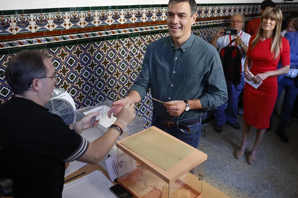 Spanish Prime Minister Pedro Sanchez (centre) casting his ballot next to his wife Begona Gomez (right) at a polling station in Madrid on Sunday. 