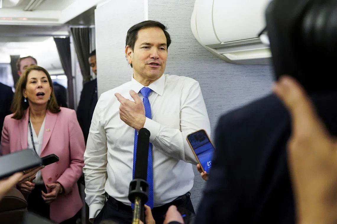 FILE PHOTO: U.S. Secretary of State Marco Rubio speaks with reporters on his plane while flying from Suriname en route to Miami, Florida, March 27, 2025. REUTERS/Nathan Howard/Pool/File photo