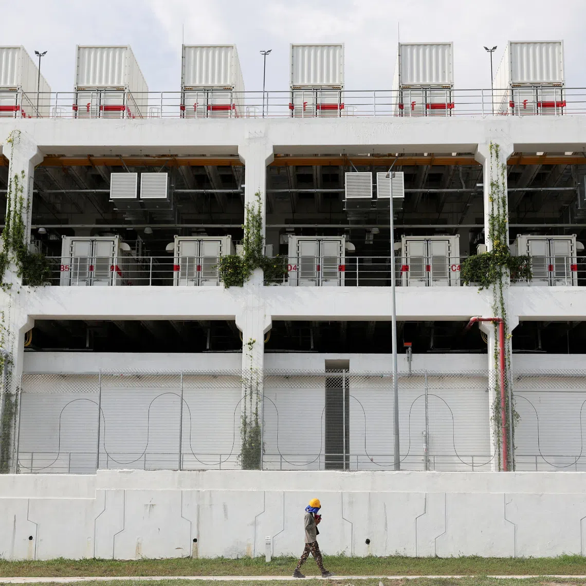 FILE PHOTO: File Photo: A worker walks past a data centre in Johor state, which has become Southeast Asia's fastest-growing data centre hub, at Gelang Patah, Malaysia May 7, 2026. REUTERS/Hasnoor Hussain/File Photo/File Photo