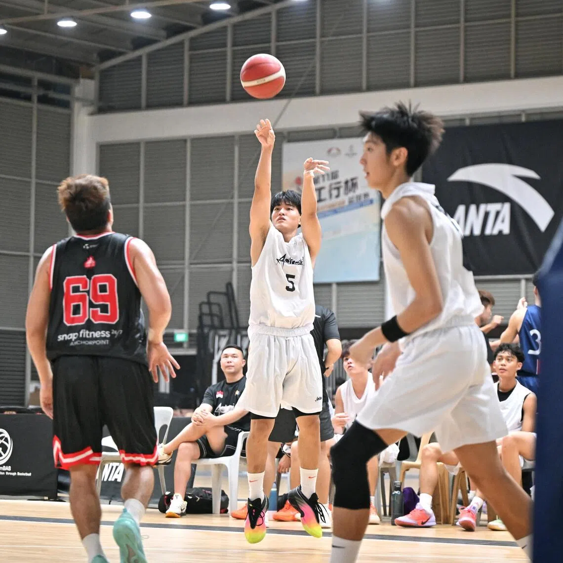 Adroit players (in white) in their first National Basketball League Division 2 game this season against Sin Kee at Singapore Basketball Centre on Oct 24.