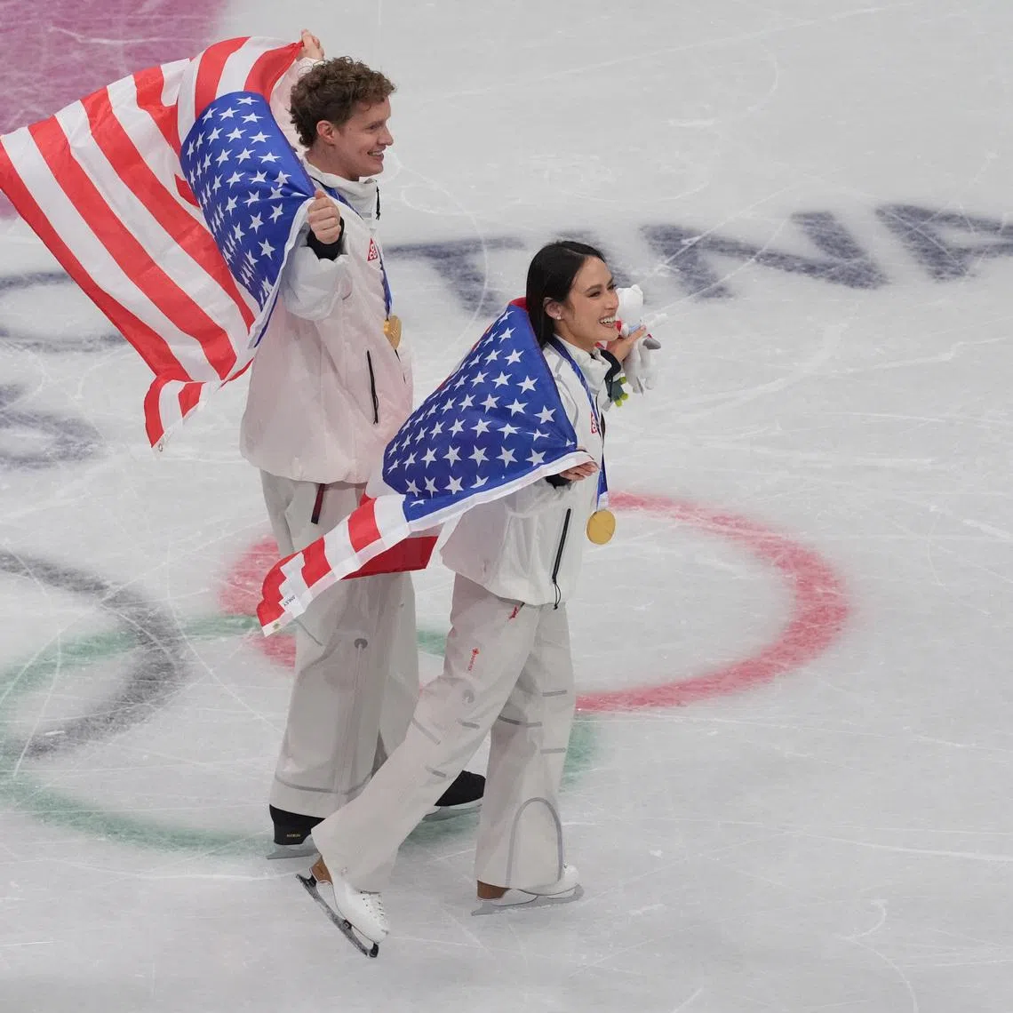 Feb 8, 2026; Milan, Italy; Ellie Kam and Danny O'Shea of the United States of America celebrate after winning gold in the figure skating team event during the Milano Cortina 2026 Olympic Winter Games at Milano Ice Skating Arena. Mandatory Credit: Amber Searls-Imagn Images