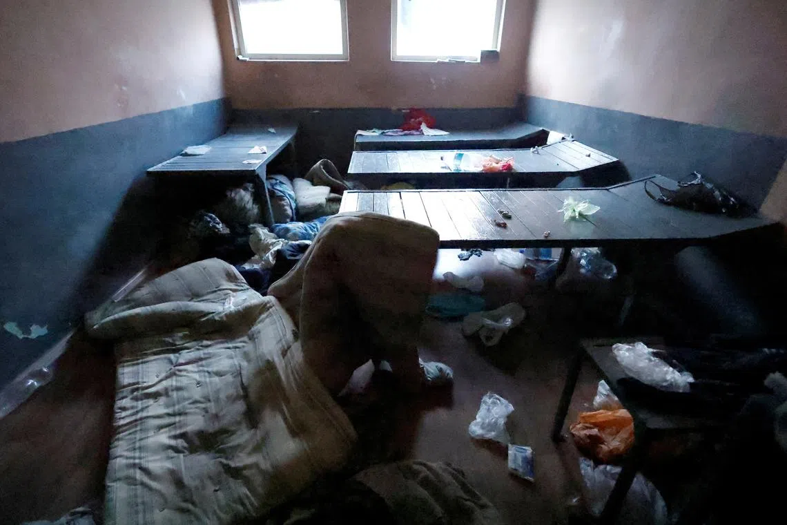 Ukrainian authorities in a prison and torture chamber set up by Russian forces in Ukraine on Oct 18, 2022.