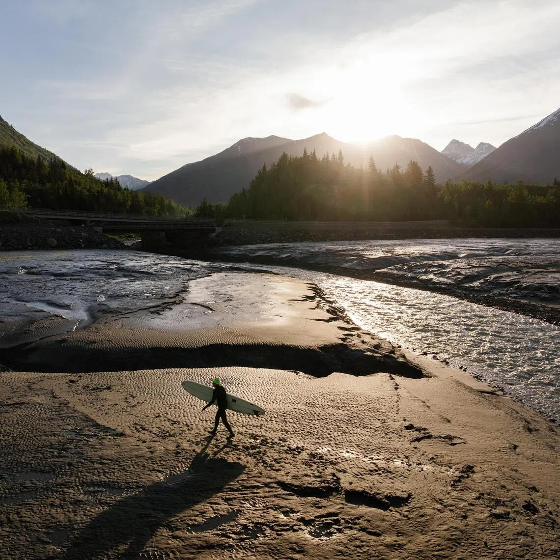 Pete Beachy walks along the shore of the Turnagain Arm near Bird Point, 48km south-east of Anchorage, Alaska on June 18, 2026. The tidal bore that rockets up the Turnagain Arm south of Anchorage can carry a surfer for an hour; it can also kill.