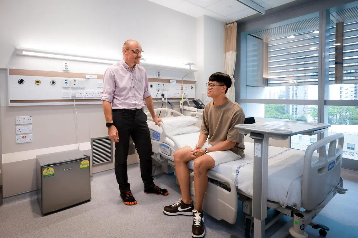 A/Prof Barnaby Young, head, Singapore Infectious Disease Clinical Research Network, and the Principal Investigator for Sing-CoV, and Goh Zhi Hao, a student and the first participant to be recruited for the human challenge study, at an NCID ward on March 12, 2025.