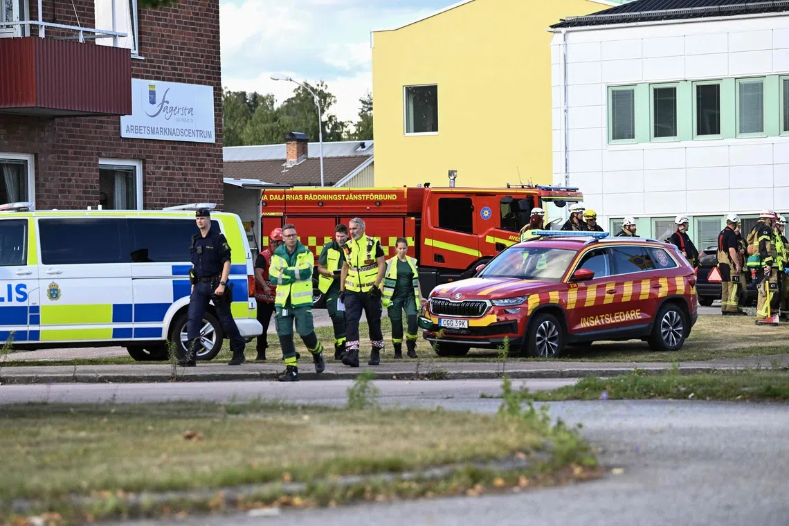 Police officers and rescue services working at the scene of a sword attack at a high school in Fagersta, central Sweden, on Aug 21.