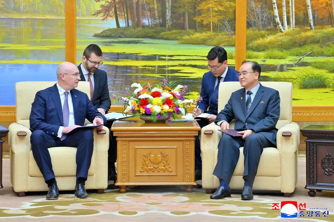 Chairman of the Standing Committee of the Supreme People's Assembly Jo Yong-won (right) meeting Russian news agency TASS director-general Andrey Kondrashov (left).