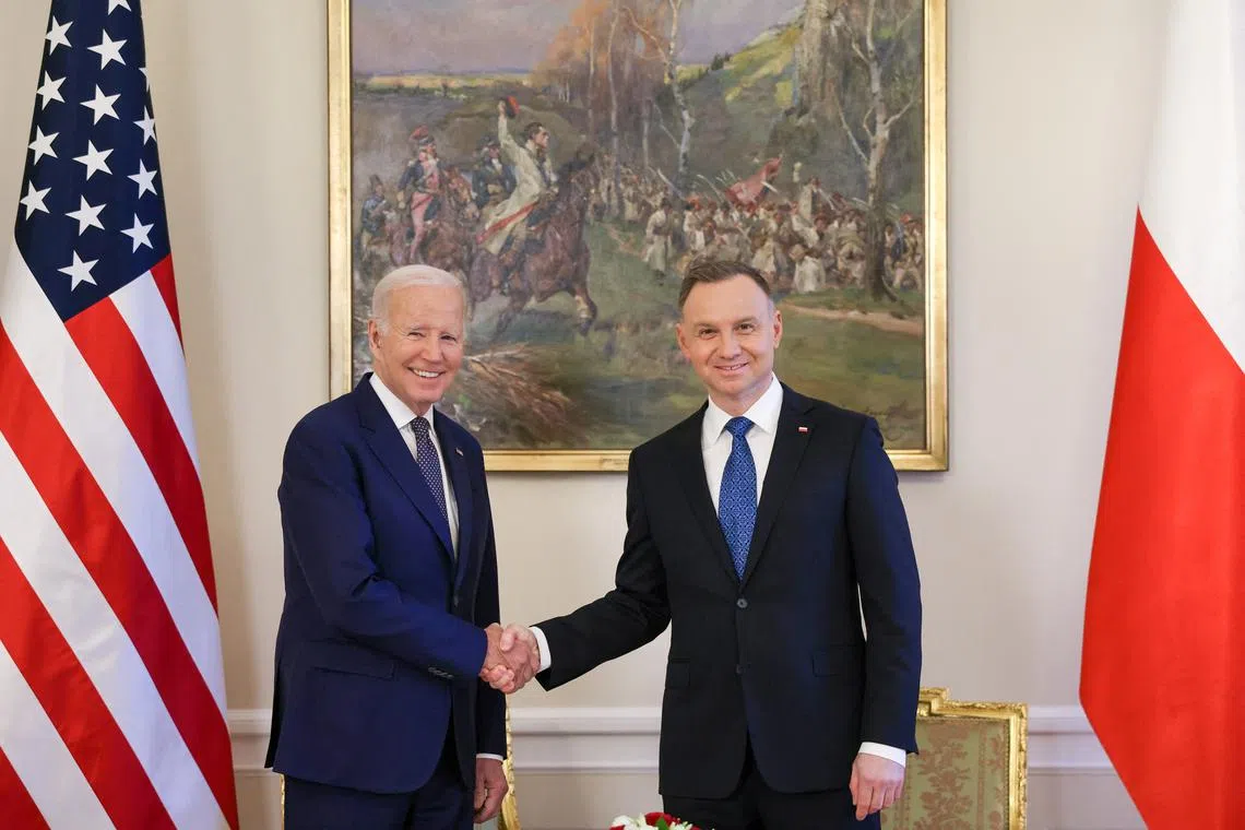 US President Joe Biden (left) being welcomed by Polish President Andrzej Duda at the Presidential Palace in Warsaw, Poland, on Feb 21, 2023.