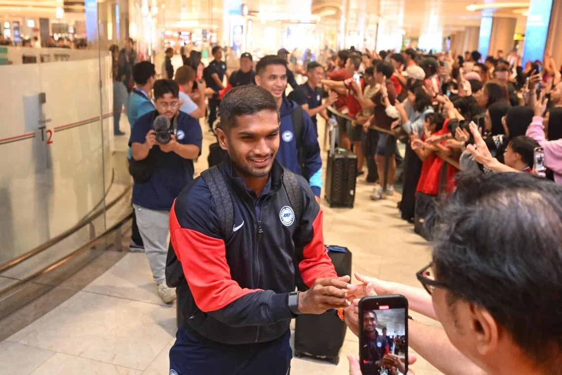 Lions captain Hariss Harun greeting fans at Changi Airport on his return from Hong Kong on Nov 19 after their historic Asian Cup qualification campaign. 