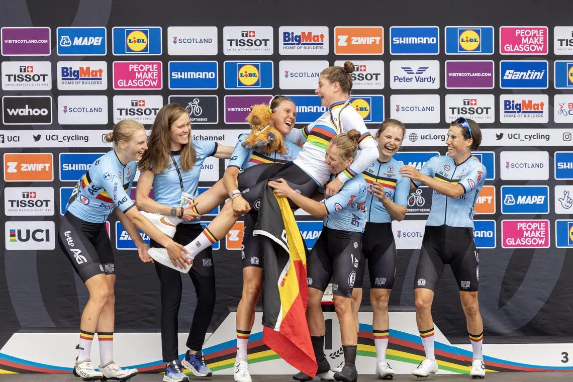 Lotte Kopecky (centre) of Belgium celebrates winning the Women Elite Road Race at the UCI Cycling World Championships 2023 in Glasgow on Sunday.