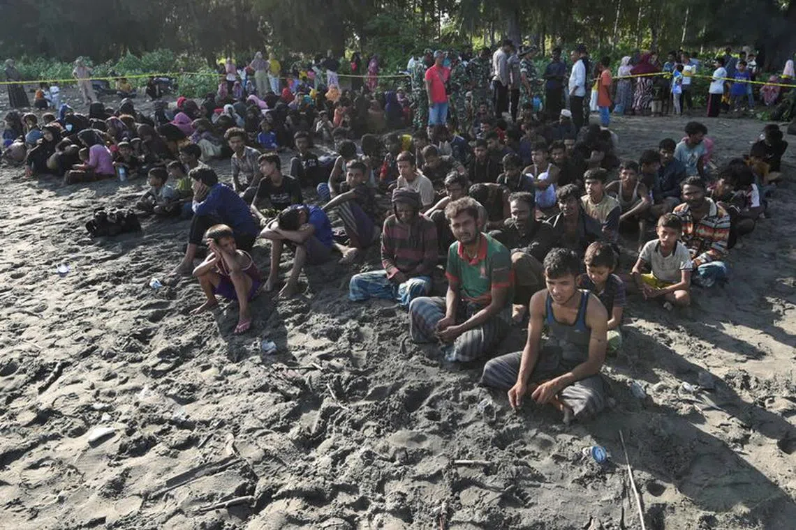 Rohingya Muslims rest on a beach after they land in Blang Raya, Pidie, Aceh province, Indonesia, December 10, 2023. REUTERS/Stringer