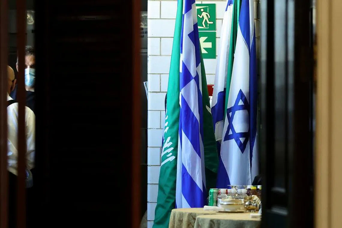 FILE PHOTO: Flags of Saudi Arabia and Israel stand together in a kitchen staging area as U.S. Secretary of State Antony Blinken holds meetings at the State Department in Washington, U.S., October 14, 2021. REUTERS/Jonathan Ernst/Pool