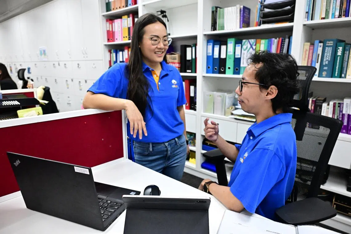 Allkin Singapore’s community worker Amos Liu and assistant senior social worker Esther Quek discuss their clients’ needs and strengths to identify opportunities for mutual support.