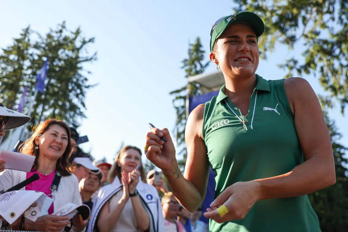 Lexi Thompson of the United States signs autographs for fans after her first round of the Women's PGA Championship at Sahalee Country Club.