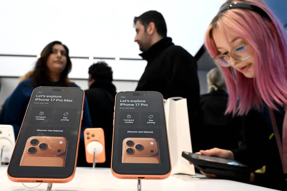 Customers explore the features of the newly launched iPhone 17 Pro at an Apple Store in Sydney on on Sept 19, 2025.