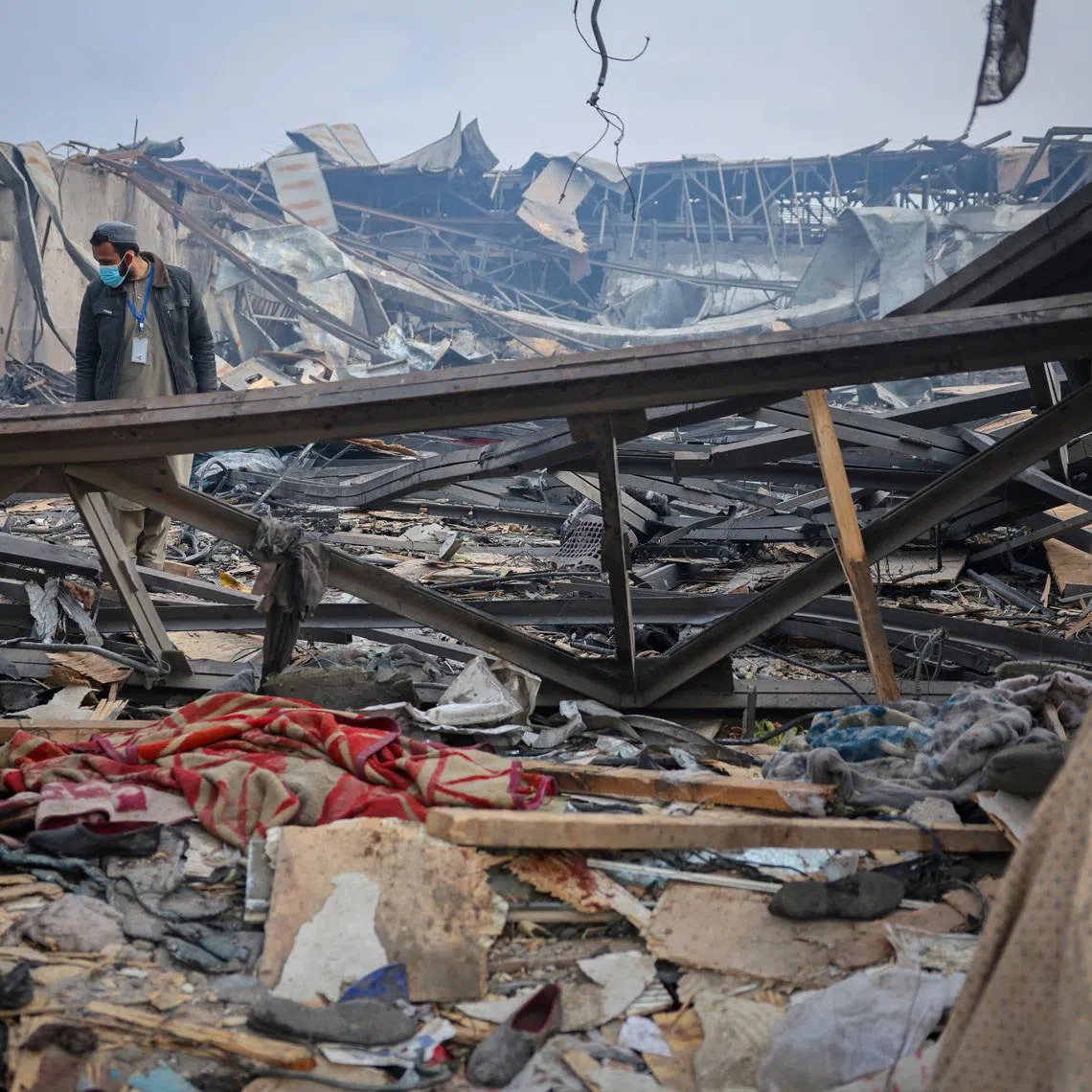 A man walks through debris at the site of a drug users rehabilitation hospital destroyed in what the Taliban said was a Pakistani air strike in Kabul, Afghanistan, March 17, 2026. REUTERS/Sayed Hassib