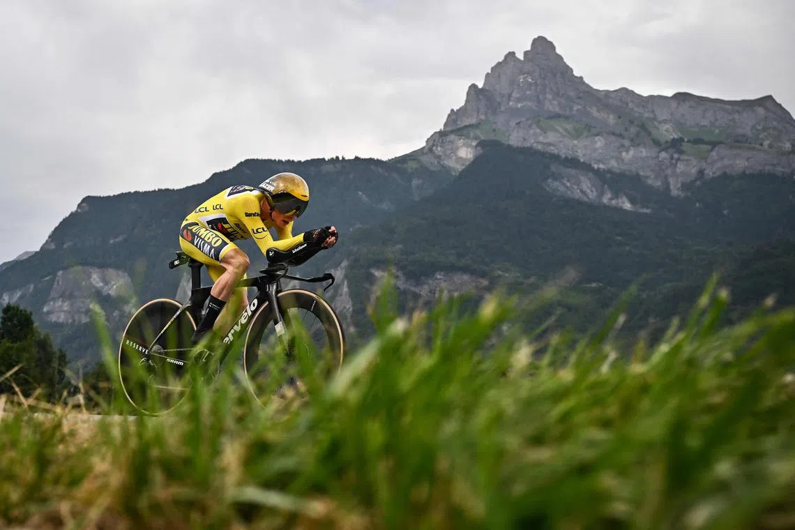 Jumbo-Visma's Danish rider Jonas Vingegaard wearing the overall leader's yellow jersey as he wins the 16th stage of the 110th edition of the Tour de France cycling race, a 22km individual time trial between Passy and Combloux, in the French Alps, on Tuesday.
