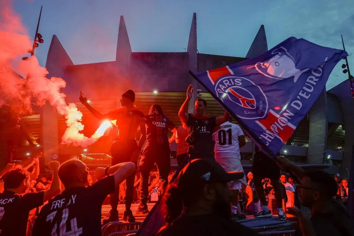 PSG supporters in Paris celebrating their team's May 30 win in the UEFA Champions League final in Hungary against Arsenal, outside the Parc des Princes stadium.