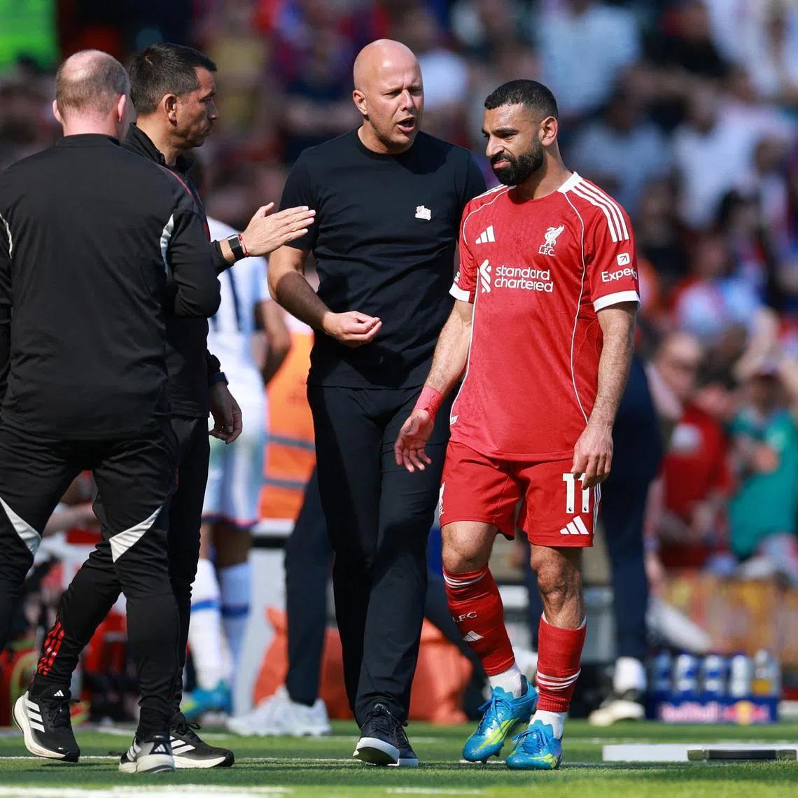 Soccer Football - Premier League - Liverpool v Crystal Palace - Anfield, Liverpool, Britain - April 25, 2026 Liverpool's Mohamed Salah with manager Arne Slot after being substituted REUTERS/Phil Noble