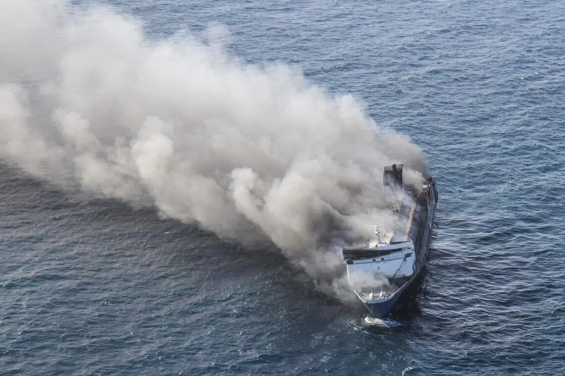 TOPSHOT - This aerial picture shows the passenger ship Mutiara Sentosa 2 catching fire in the waters off Madura island, East Java, on August 2, 2026. Five people have been found dead, 41 are missing and 225 were rescued after an Indonesian ferry caught fire while at sea on August 2, search and rescue officials said. (Photo by FRIDA PERKASA / AFP)