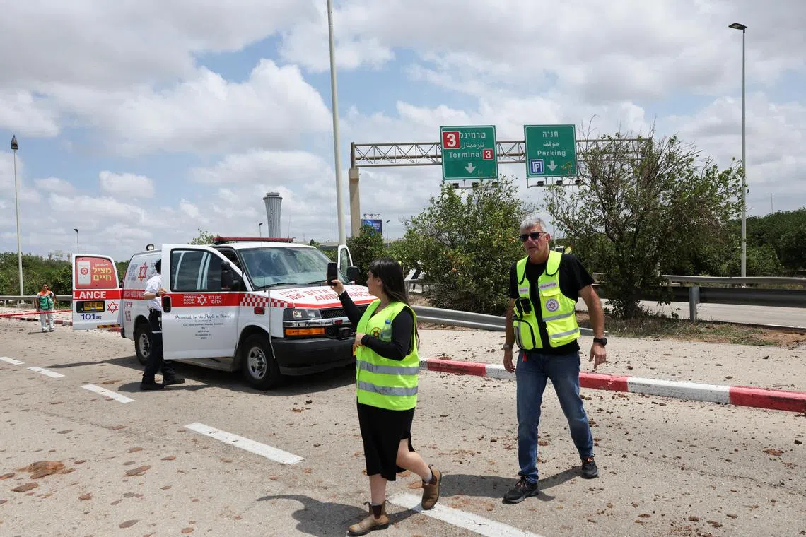 Emergency personnel work at the site a missile attack, launched from Yemen, at the entrance of Ben Gurion Airport, in Tel Aviv, Israel May 4, 2025. REUTERS/Nir Elias