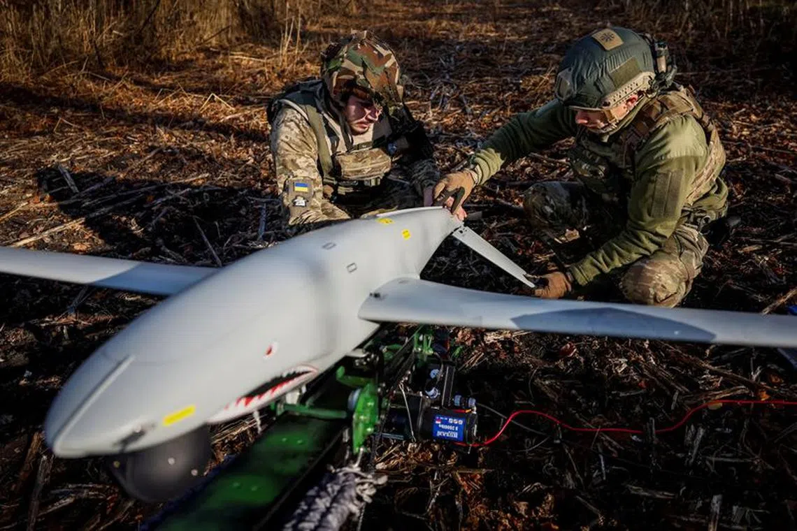 FILE PHOTO: Servicemen of the 15th Separate Artillery Reconnaissance Brigade of the Armed Forces of Ukraine prepare a Shark drone for launching, amid Russia's attack on Ukraine, in Kharkiv region, Ukraine, October 30, 2023. REUTERS/Alina Smutko/File Photo