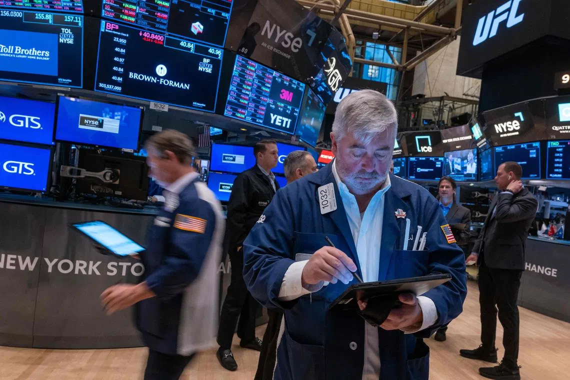 Traders work on the New York Stock Exchange floor, on Nov 12, in New York City.