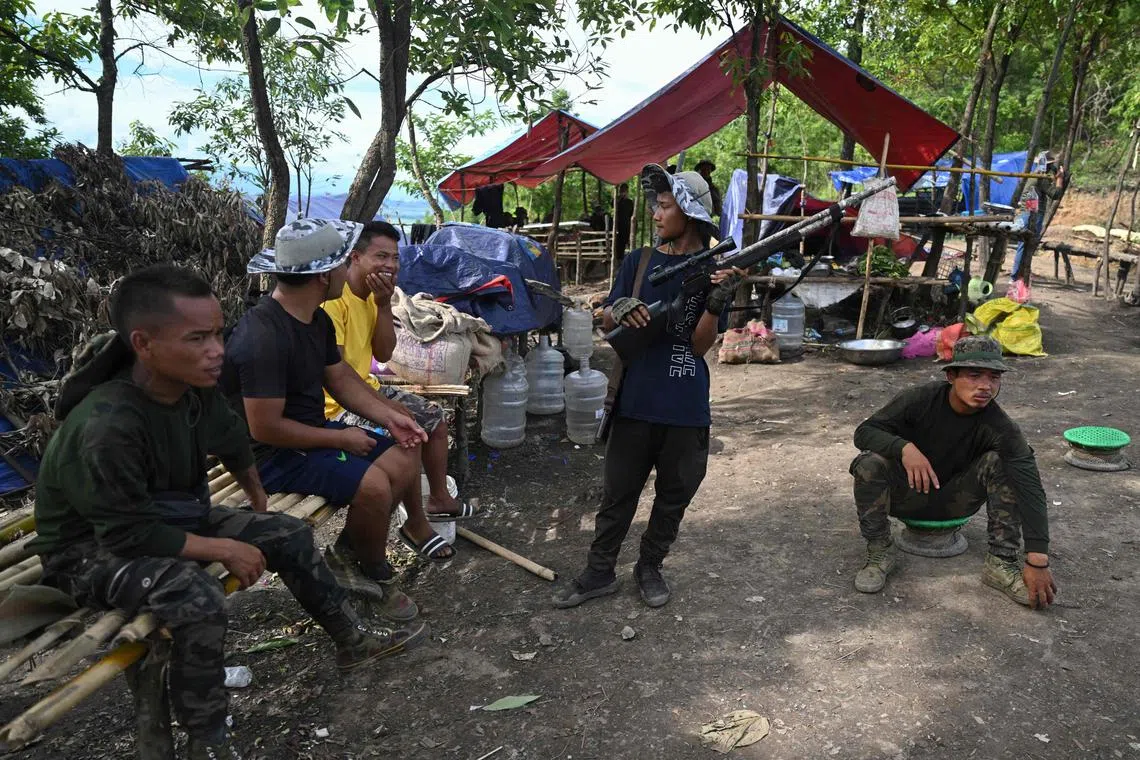 Tribal armed volunteer combatants at a makeshift camp during ongoing ethnic violence in India's Manipur state on July 24.