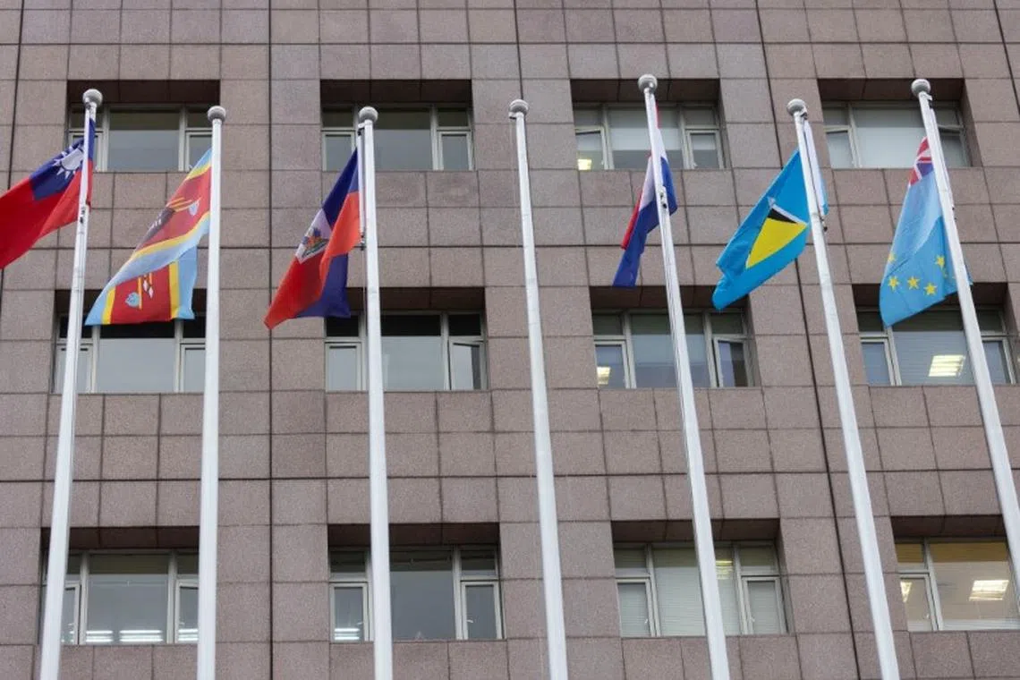 An empty flag pole where Nauru's flag used to fly is pictured next to flags of other countries at the Diplomatic Quarter which houses embassies in Taipei, Taiwan January 15, 2024. REUTERS/Carlos Garcia Rawlins