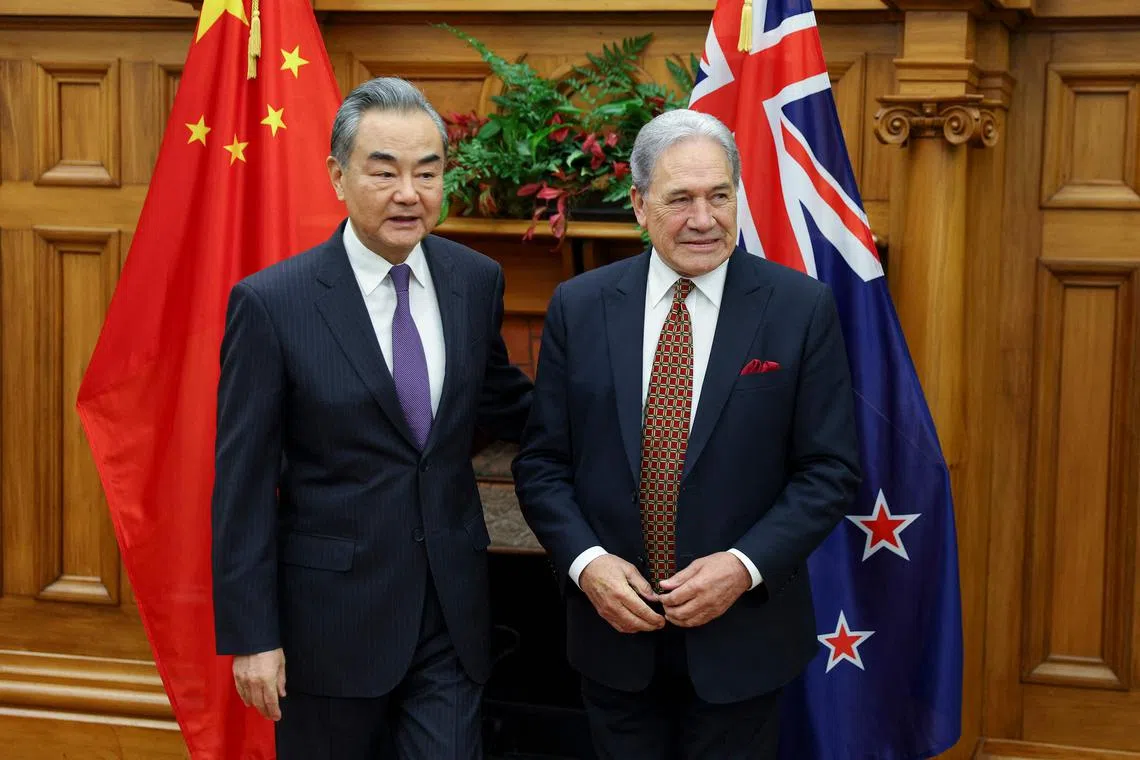 China's Foreign Minister Wang Yi (left) and New Zealand's Minister of Foreign Affairs Winston Peters arrive for a bilateral meeting at Parliament in Wellington on March 18, 2024.