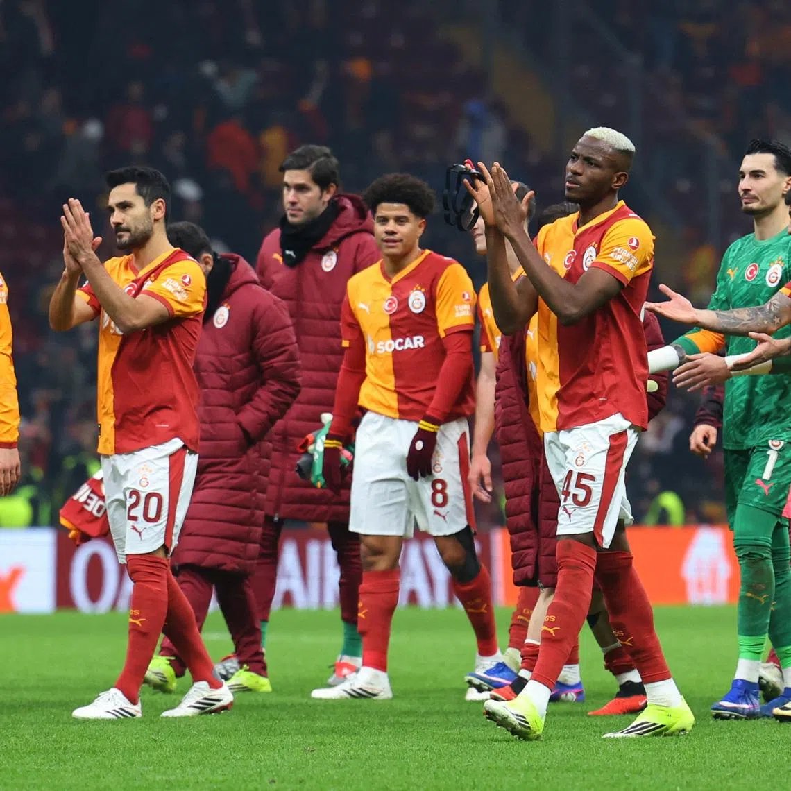 Soccer Football - UEFA Champions League - Galatasaray v Atletico Madrid - Rams Park, Istanbul, Turkey - January 21, 2026 Galatasaray's Ilkay Gundogan and Victor Osimhen with teammates applaud fans after the match REUTERS/Murad Sezer