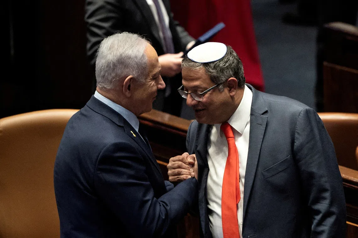 Israeli Prime Minister Benjamin Netanyahu and Itamar Ben-Gvir shake hands as Israel’s government approves Netanyahu’s proposal to reappoint Itamar Ben-Gvir as minister of National Security.
