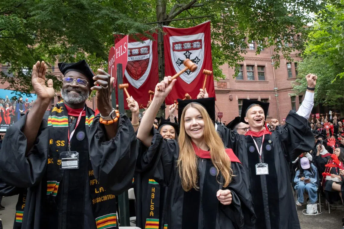 Harvard Law School graduates cheer during the 374th Harvard Commencement in Harvard Yard in Cambridge, Massachusetts, on May 29.