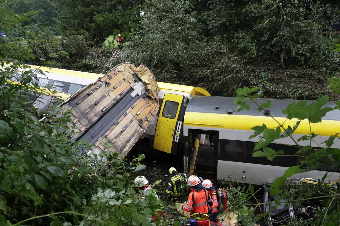 Rescue forces work at the site of a derailed train near Riedlingen near Biberach, on July 27.