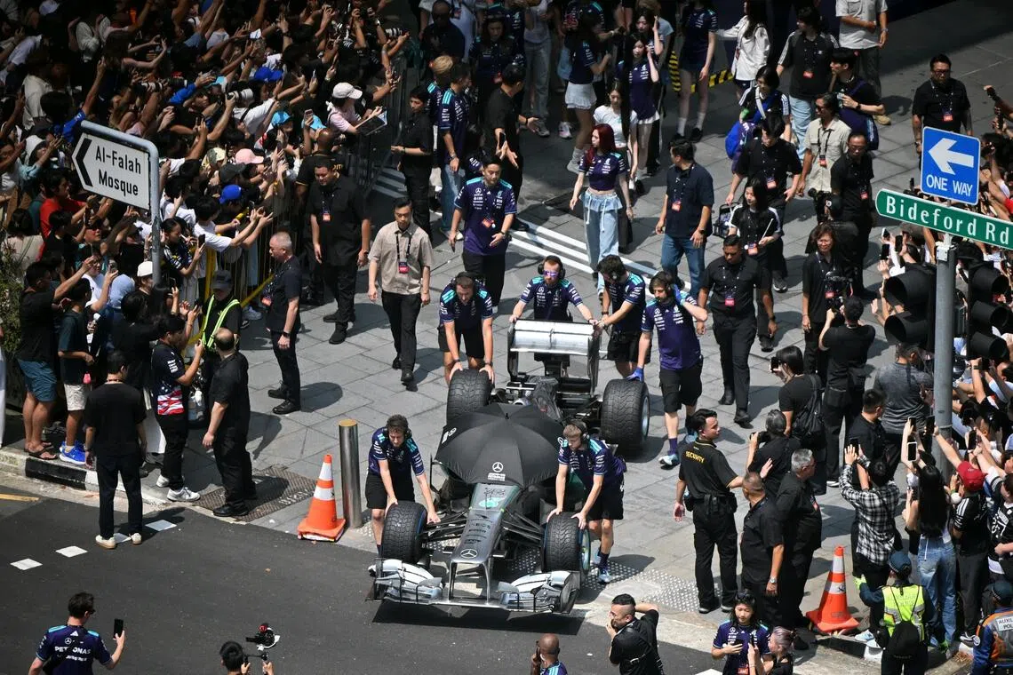 A Formula One car being pushed out onto Orchard Road for the Orchard Ignition event on Aug 30.
