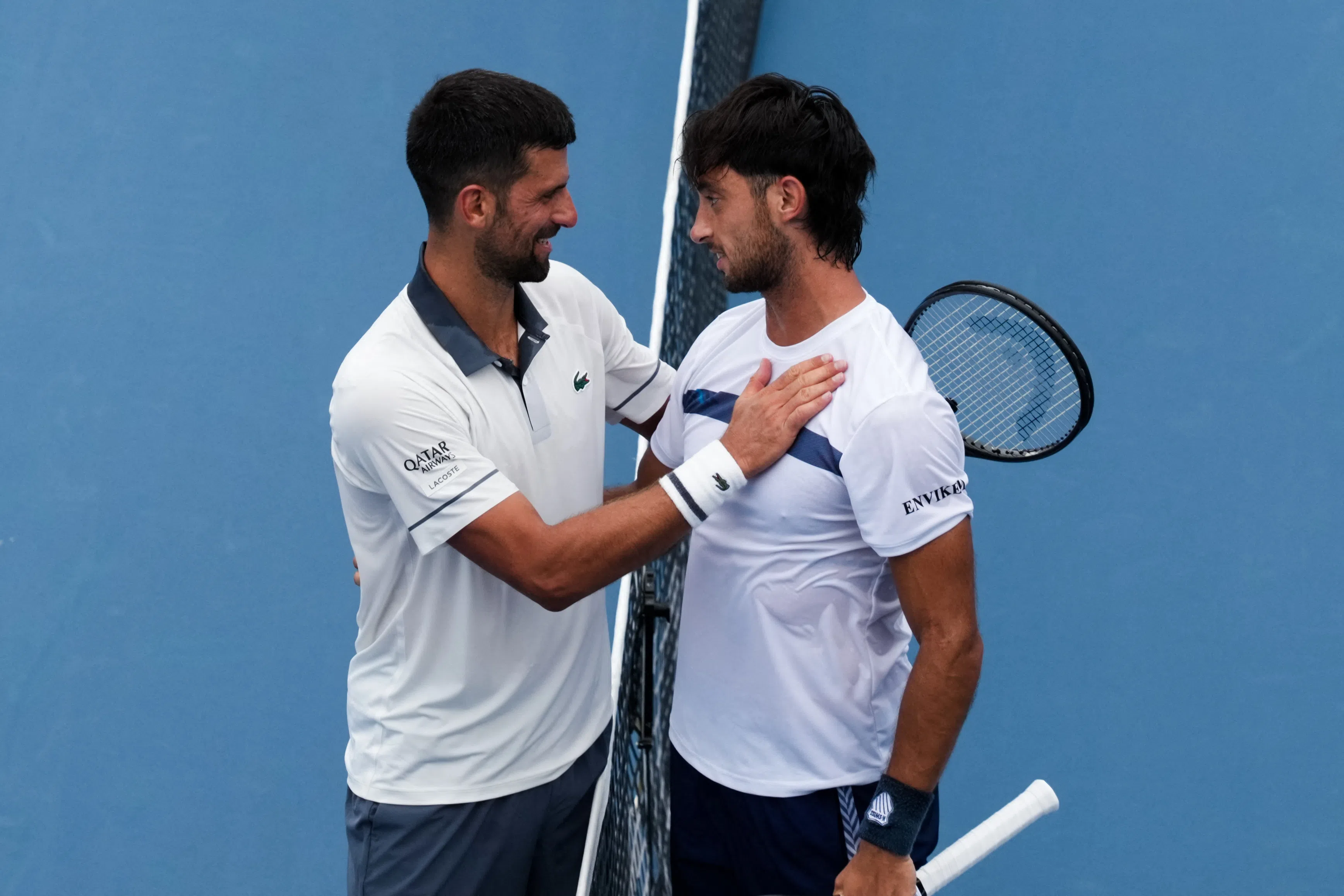 Aug 15, 2026; Mason, OH, USA;  Thiago Agustín Tirante (ARG) meets with Novak Djokovic (SRB) after their match during the Cincinnati Open at Lindner Family Tennis Center. Mandatory Credit: Aaron Doster-Imagn Images