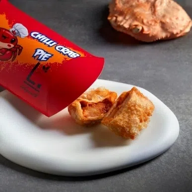 (Clockwise from top left) Labyrinth's elevated spin on prawn noodles, chilli crab pie and ketupat served with the satay pigeon.