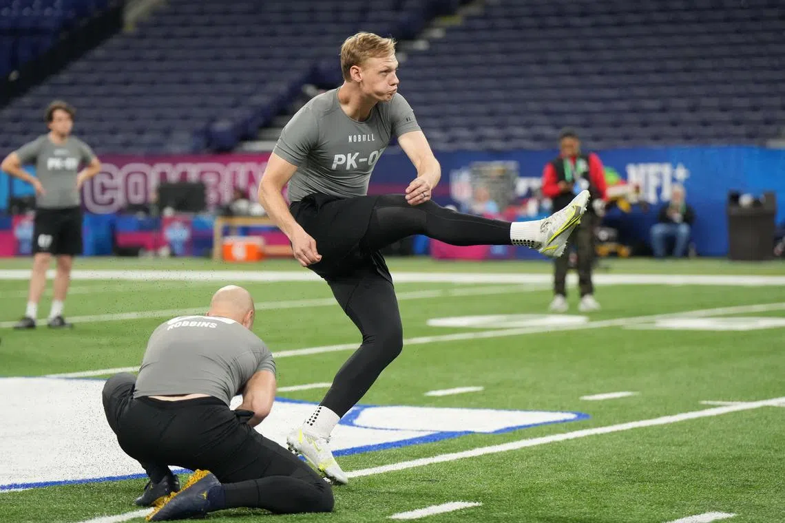 Mar 3, 2023; Indianapolis, IN, USA; Auburn place kicker Anders Carlson (PK03) participates in drills during the NFL Scouting Combine at Lucas Oil Stadium. Mandatory Credit: Kirby Lee-USA TODAY Sports