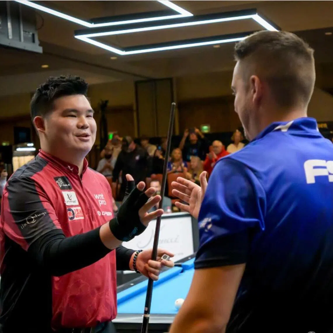 Aloysius Yapp (left) with Spain's Francisco Sanchez Ruiz after beating him 13-11 in the final to win his third consecutive International 9-Ball Open title.