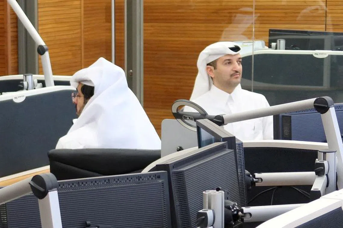 One of Qatar’s lead negotiators Abdullah Al Sulaiti (R) works inside an operation room set up to coordinate the truce and release of hostages between Israel and the Palestinian Islamist group Hamas, at the National Command Centre in Doha, Qatar November 26, 2023.   REUTERS/Imad Creidi/File Photo