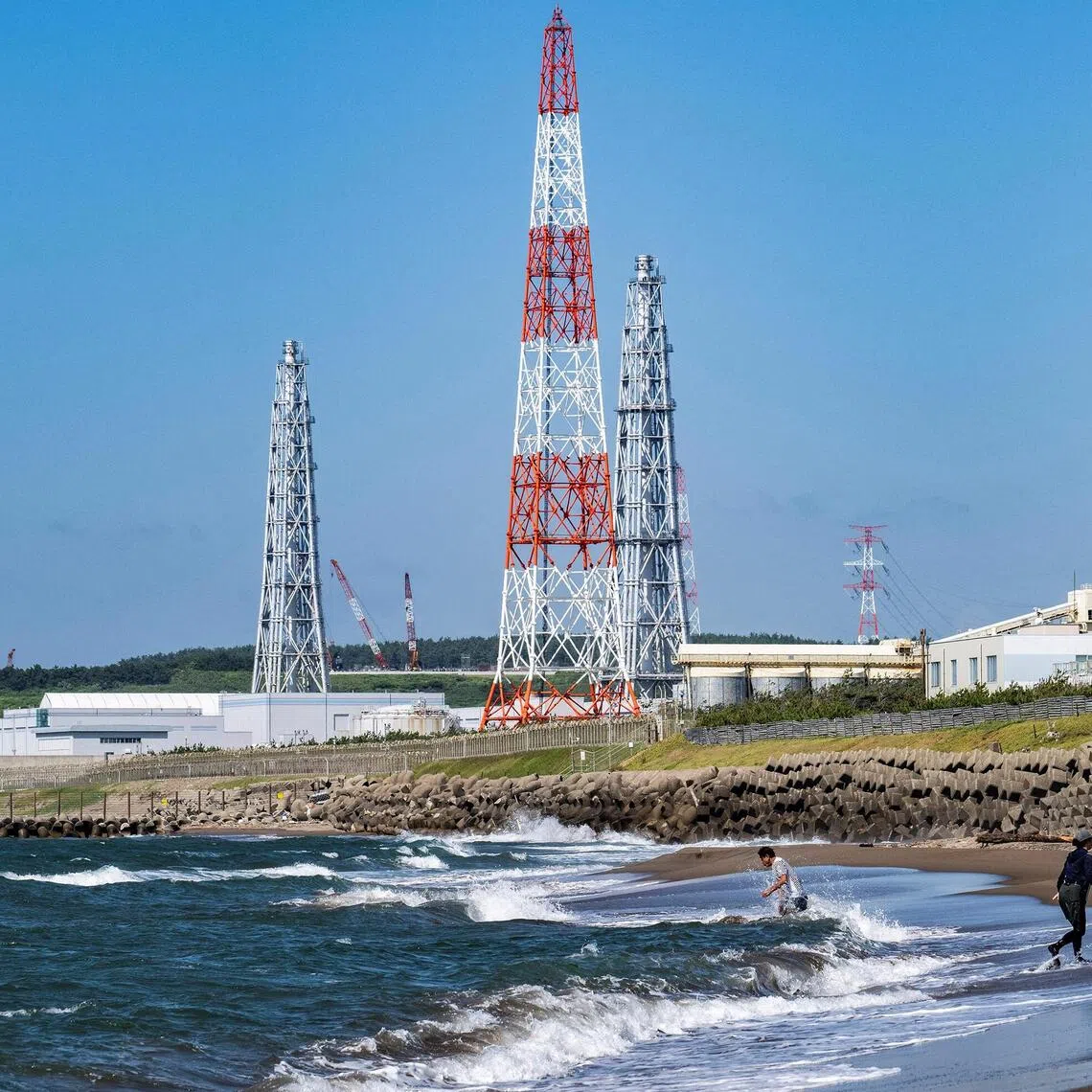 People visiting Arahama beach in front of the Kashiwazaki-Kariwa nuclear power station in Kashiwazaki, in Japan's Niigata prefecture, on Aug 5, 2024.