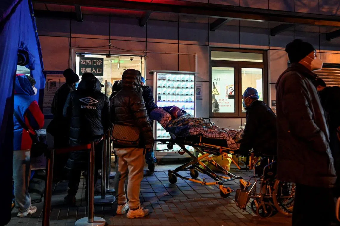 Emergency health workers transport a patient to a fever clinic at a hospital in Beijing, on Dec 21, 2022.