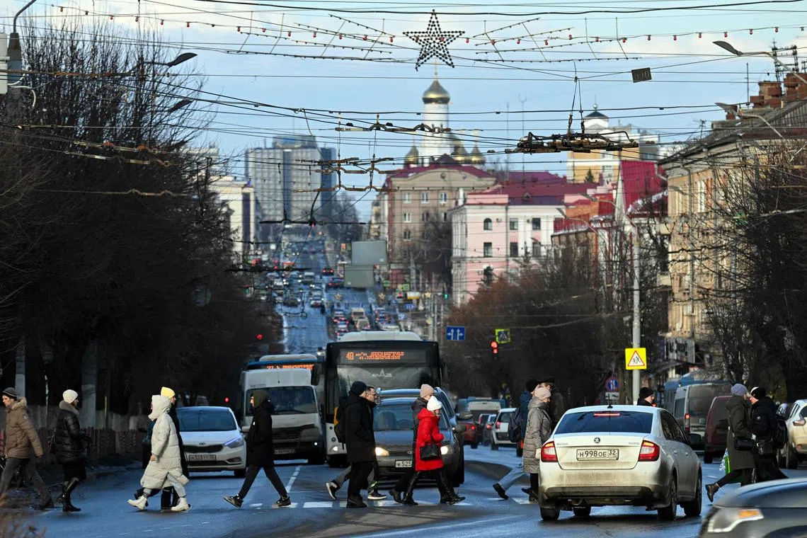 Pedestrians cross Lenin street, named after Soviet State founder Vladimir Ilyich Lenin, in Bryansk, on March 3, 2023. 