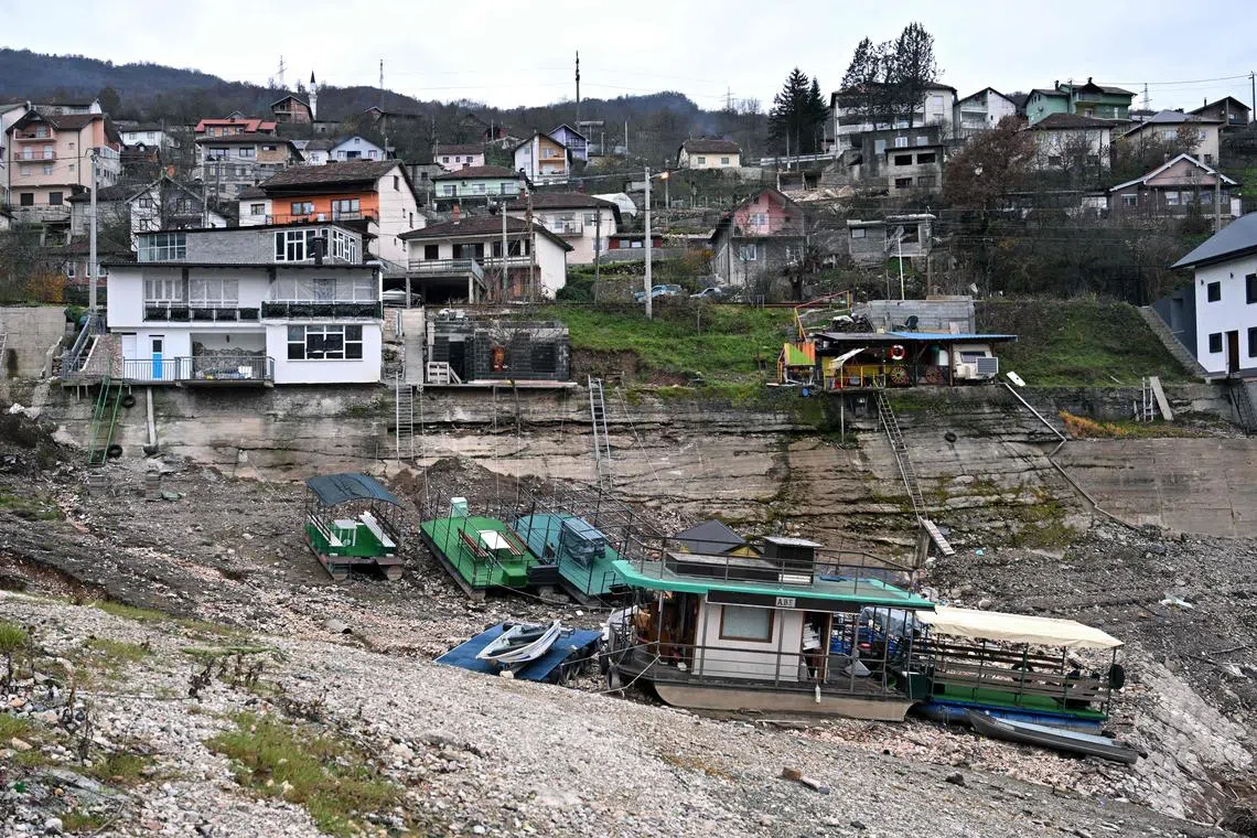 Boats and rafts on the shore of Lake Jablanicko, through which the Neretva River flows, near the Bosnian town of Konjic, on Dec 5.
