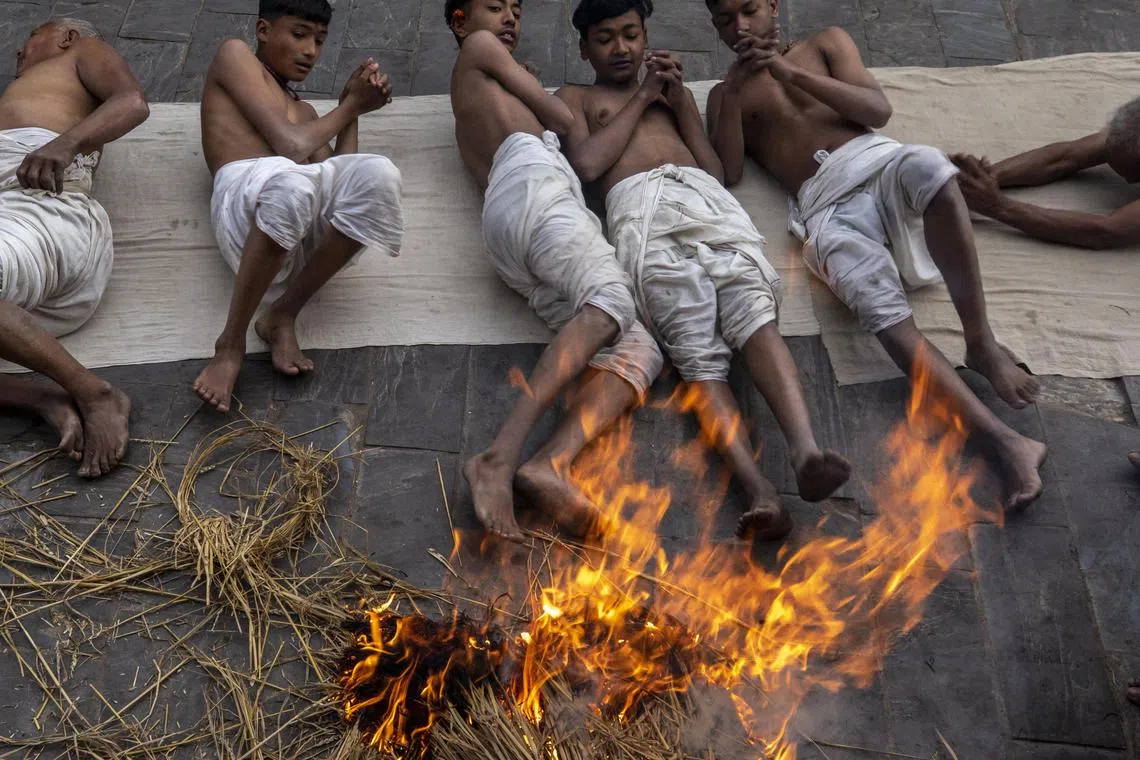 Nepalese Hindu devotees roll on the ground during the month-long Madhav Narayan festival in Bhaktapur, Nepal, Jan 26, 2023. The festival takes place for a full month and is devoted to religious fasting, holy bathing and the study of the Swasthani book, a chapter or story of which is read each evening by priests or heads of households to the gathered family. Thousands of married women and dozens of male devotees concluded their month-long fast for a better life and peace in the country at various temples.