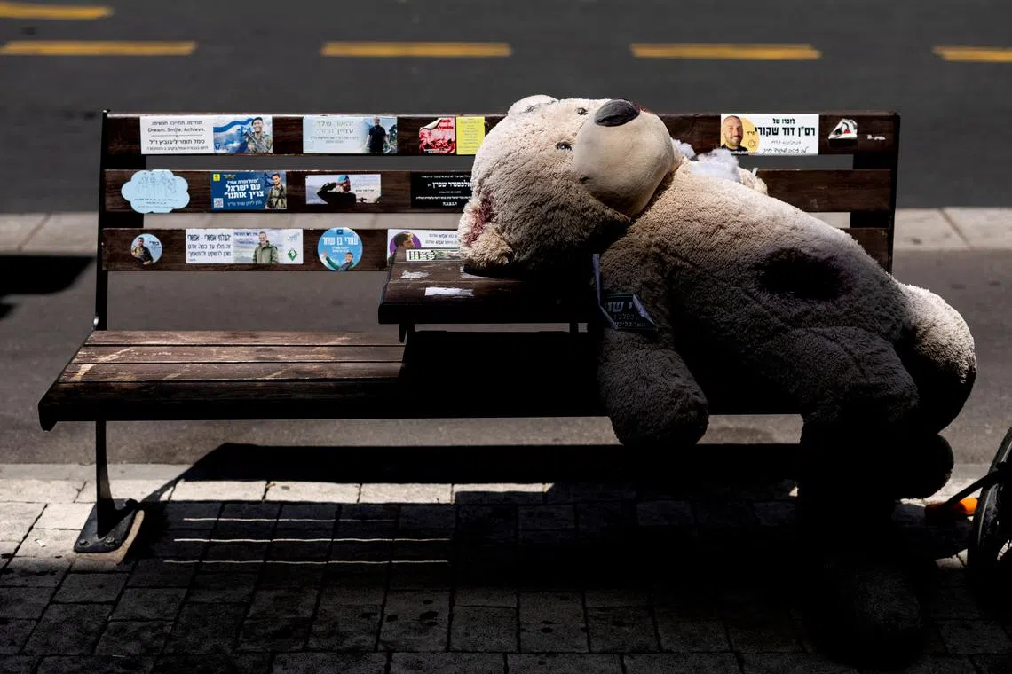 A teddy bear symbolizing hostages kidnapped during the deadly October 7 attack on Israel by Hamas, is placed on a bench, in Tel Aviv, Israel, on June 18, 2024. 