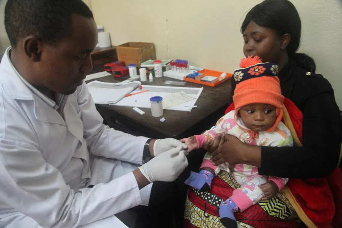 FILE PHOTO: A doctor tests a child for malaria at the Ithani-Asheri Hospital in Arusha, Tanzania, May 11, 2016. REUTERS/Katy Migiro/File Photo