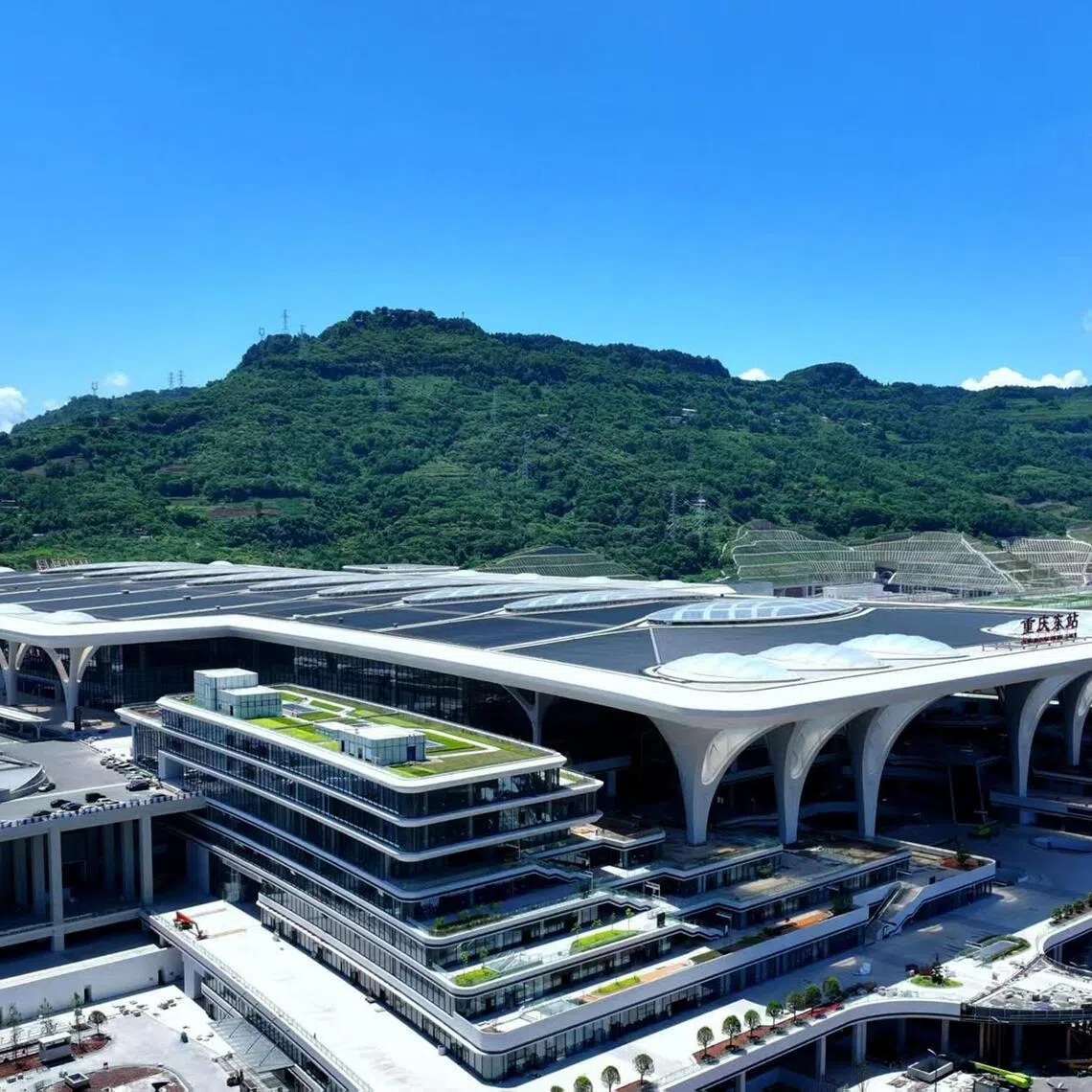 awinland -
The world’s largest high-speed rail station - Chongqingdong - that opened its doors in June this year is a landmark in the historic Nan’an district, flanked by some of the country’s most modern tracks that can facilitate the movement of train carriages up to speeds of 350 km/h. Roughly the size of 170 football fields - it can accommodate 10,000 passengers and visitors every hour. The eight-storey station with six funnel-shaped pillars at its entrance, resembling the municipality’s signature white fig trees and their wide-spreading canopies, is the latest symbol of Chongqing’s development. Mr Xi has labelled the city a “comprehensive transportation hub for the opening of inland cities”.


under Foreign By and Copyright: Handout by Ni Qiansong